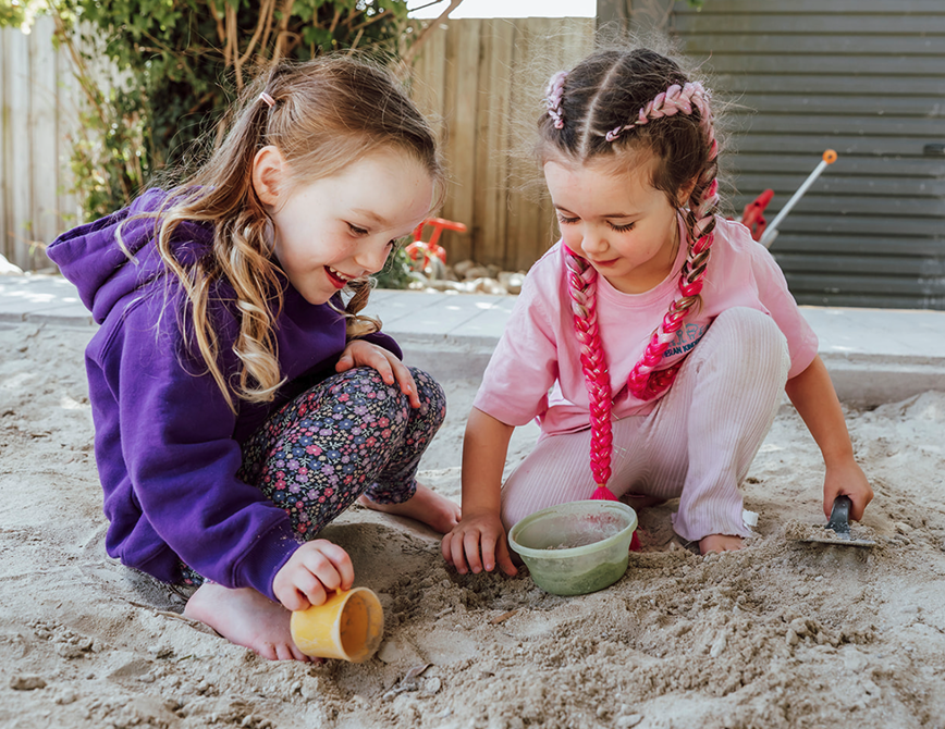 Two young children exploring outdoors